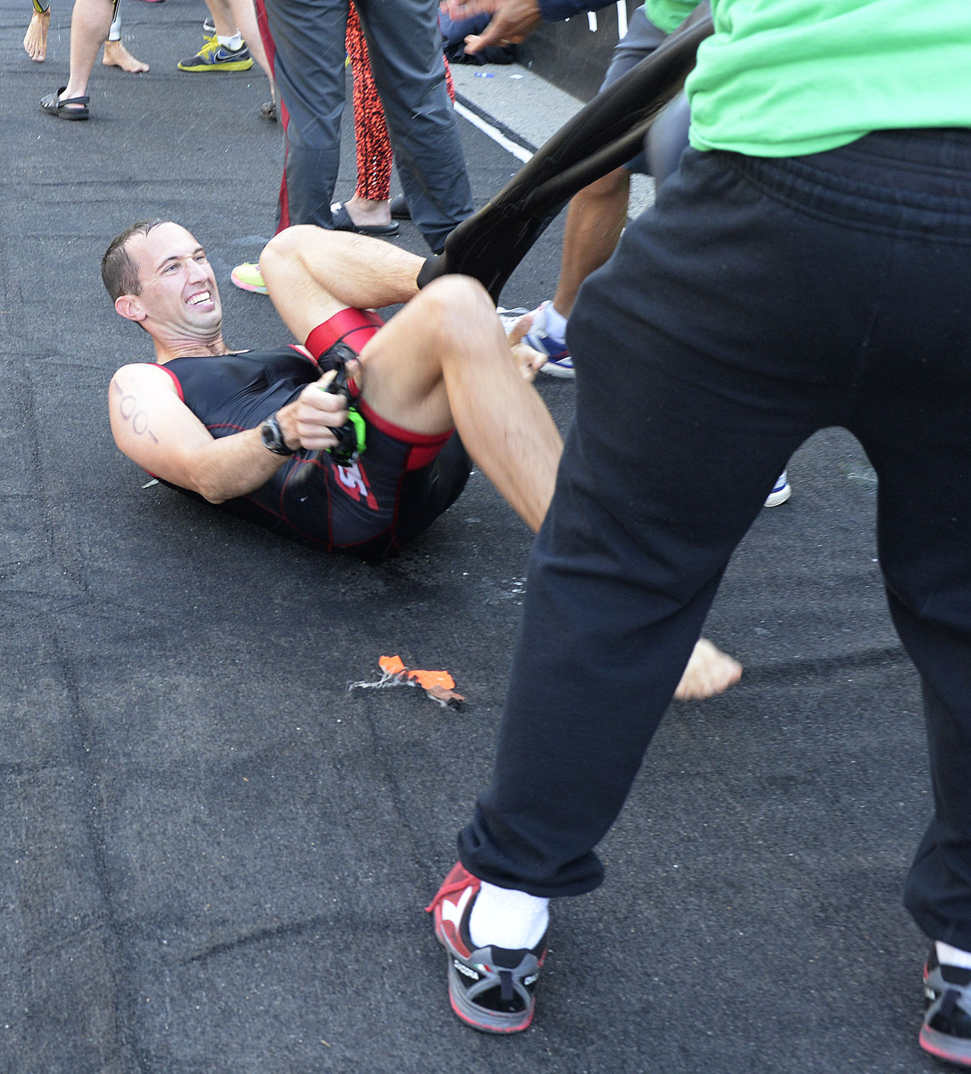 Volunteers help swimmers out of wetsuits